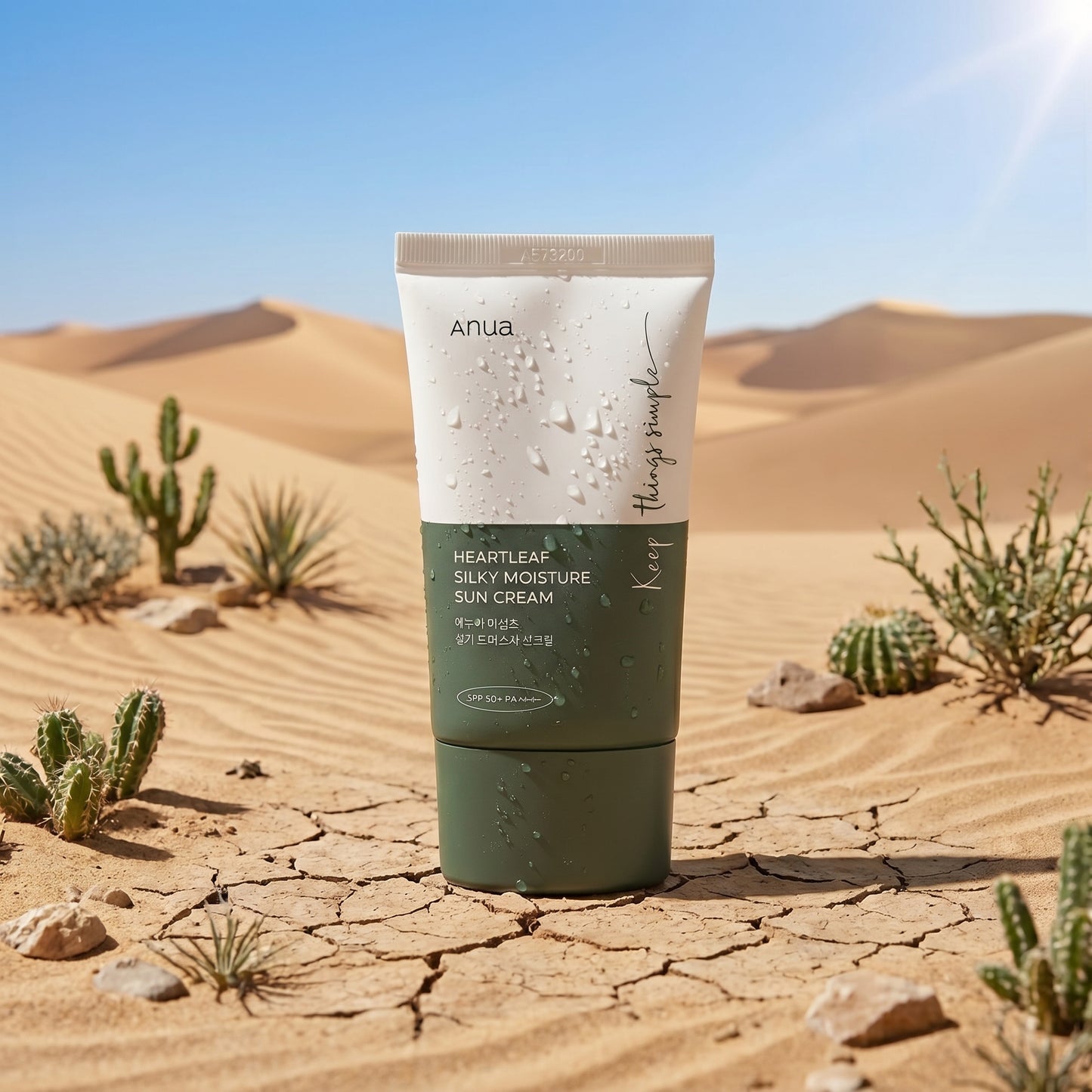 Tube of Anua sunscreen cream in a desert setting with cacti.